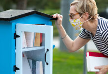 Woman looking into outside library shelf