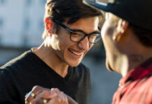 Two men shaking hand and laughing