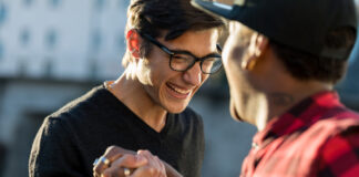 Two men shaking hand and laughing