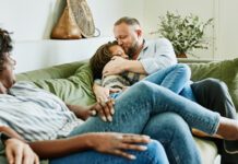 Dad hugging daughter on couch