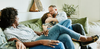 Dad hugging daughter on couch