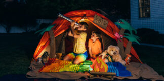 Two boys camping and looking at the stars