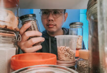 Man looking through refrigerator for food