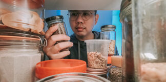 Man looking through refrigerator for food