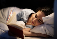 Woman reading book in bed