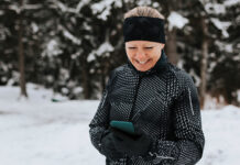 Happy woman outside looking at her phone