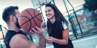 Young couple playing basketball