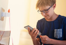 Boy plugging in phone