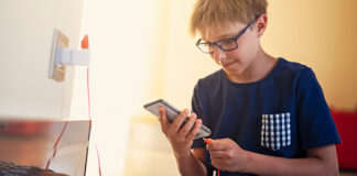 Boy plugging in phone