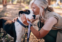 Woman cuddling her dog
