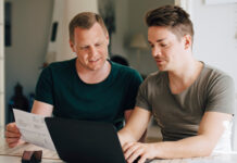 Two men sitting at a computer planning together