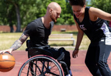 Person in wheelchair playing basketball