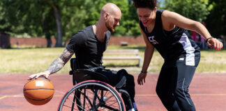 Person in wheelchair playing basketball