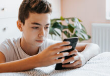 Pre-teen looking at cell phone