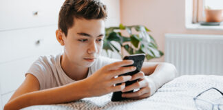 Pre-teen looking at cell phone