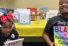 Yonge girls displaying books that celebrate Black History Month