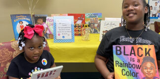 Yonge girls displaying books that celebrate Black History Month