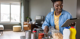 Woman preparing to cook with canned food ingredients