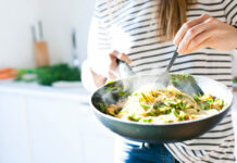 Woman holding a large bowl of pasta