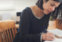 Woman writing in notebook