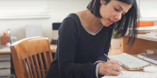 Woman writing in notebook