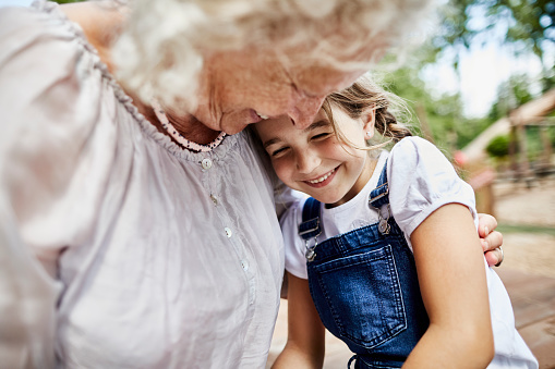 Grandma embracing her granddaughter.